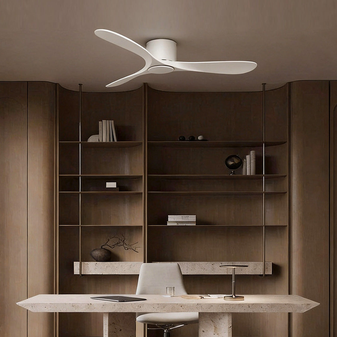 White ceiling fan illuminating a contemporary home office with wooden shelves and a desk.