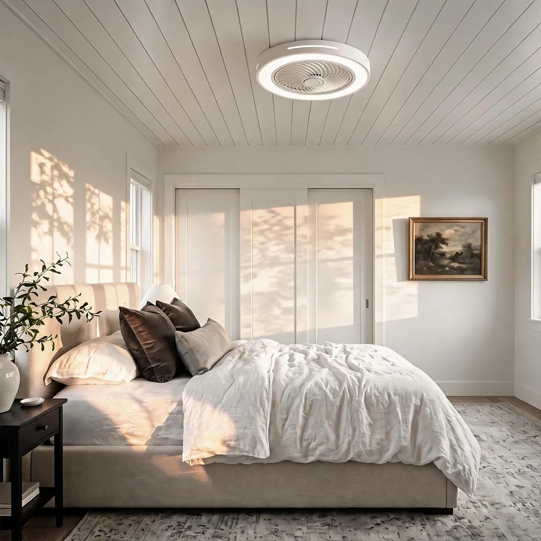 White ceiling fan flush mount with light installed in a sunlit bedroom with a paneled ceiling and modern decor.