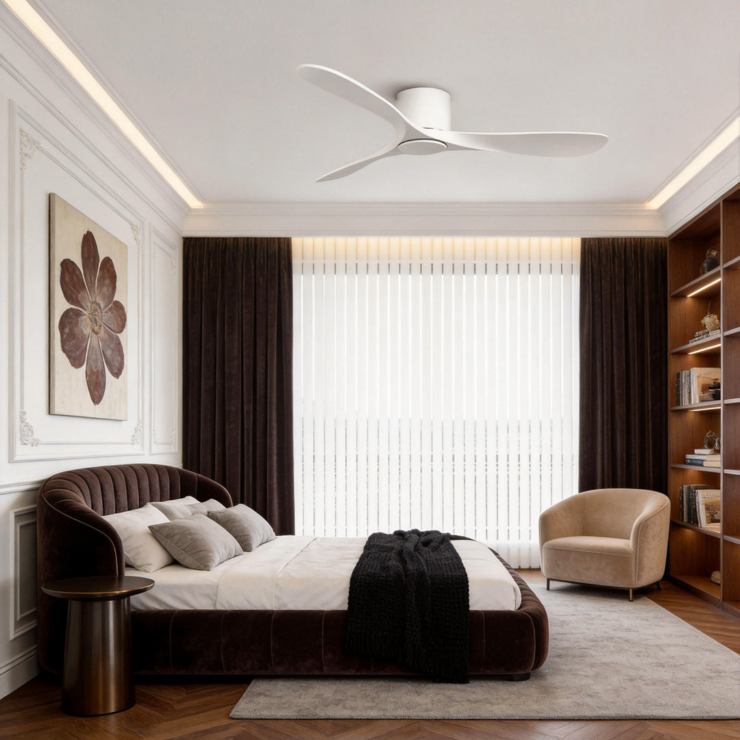 White ceiling fan adding a modern touch to a bedroom with a round bed and large windows.
