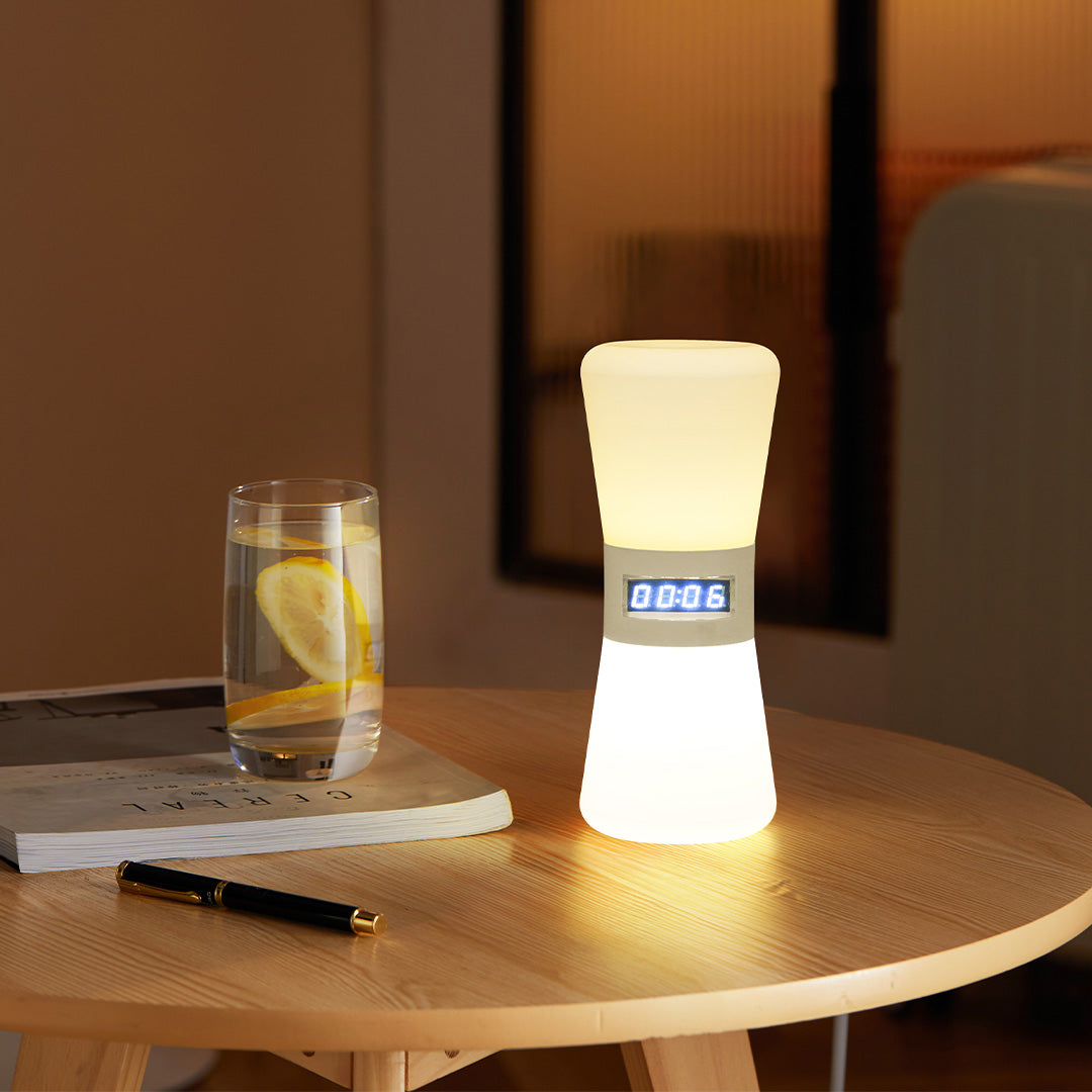 White cylindrical USB rechargeable table lamp creating cozy atmosphere on wooden dining surface