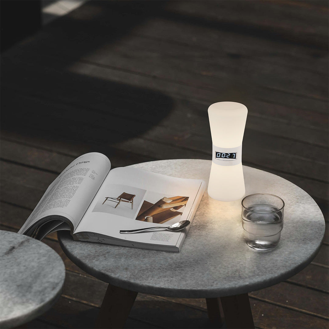 White cylindrical USB rechargeable table lamp on gray surface demonstrating modern minimalist style