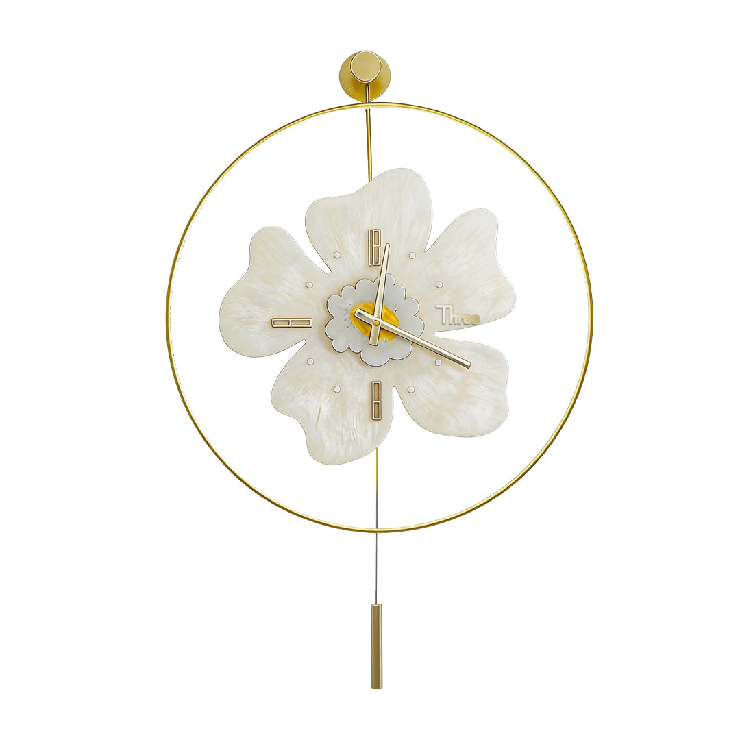 White decorative wall clock with light and gold pendulum isolated on a white background.