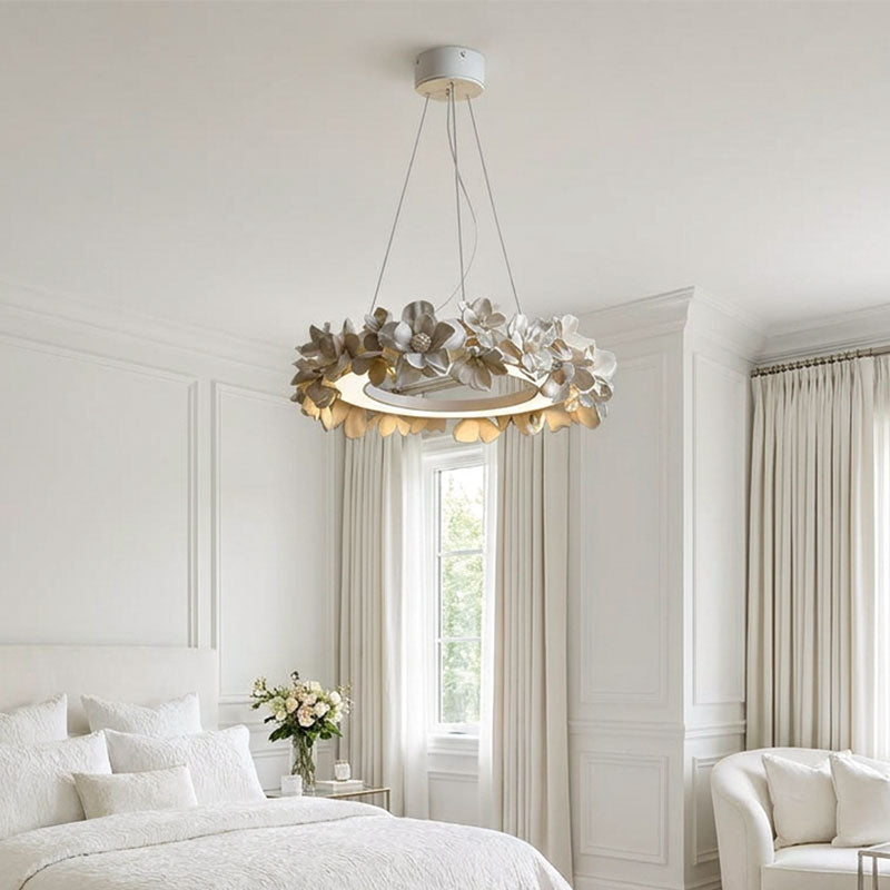 White dining room chandelier installed in a bright bedroom with a floral ring silhouette.