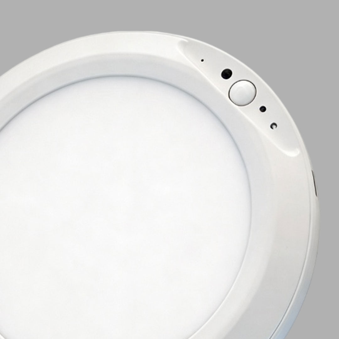 Close-up detail of a white flush mount ceiling light with side control buttons