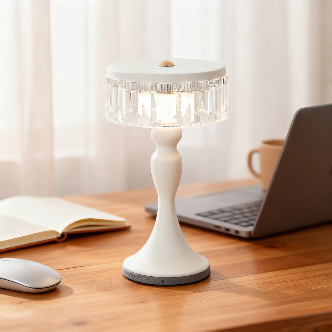 White base forged iron table lamps style on a wooden office desk next to a laptop and mouse in a bright workspace.