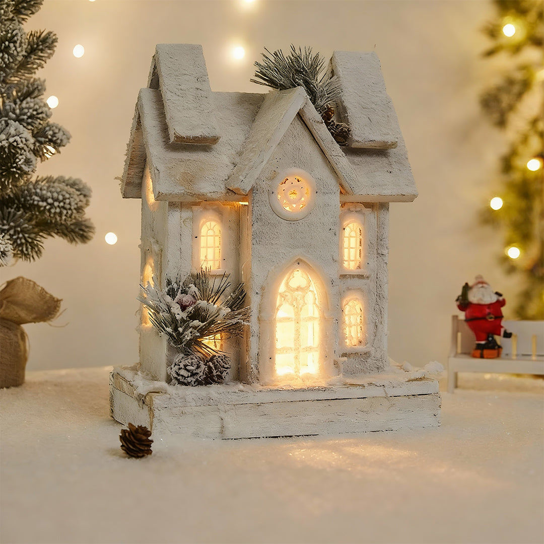 White frosted double-roof chalet version of light up wooden christmas houses for winter wonderland displays.