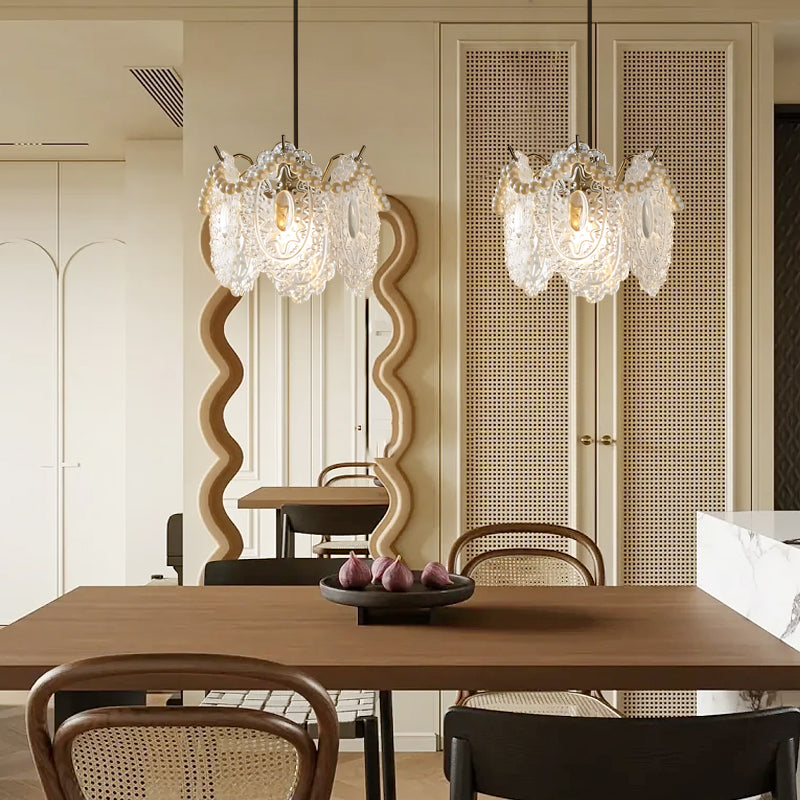 Close-up of white glass pendant lights with detailed craftsmanship and warm illumination.