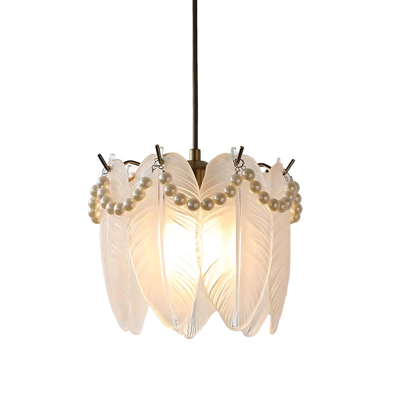 White glass pendant lights with a soft glow, enhancing the elegance of a dining room.