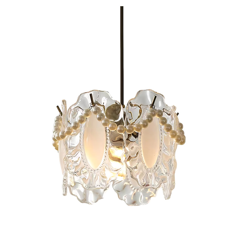 White glass pendant lights with a unique shape, hanging above a wooden dining table.