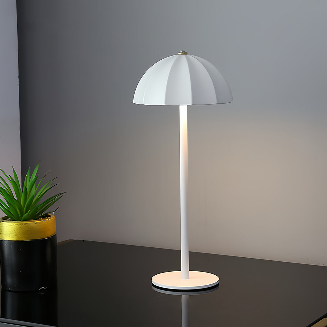 White iron table lamps illuminating contemporary workspace with plant and dark curtains
