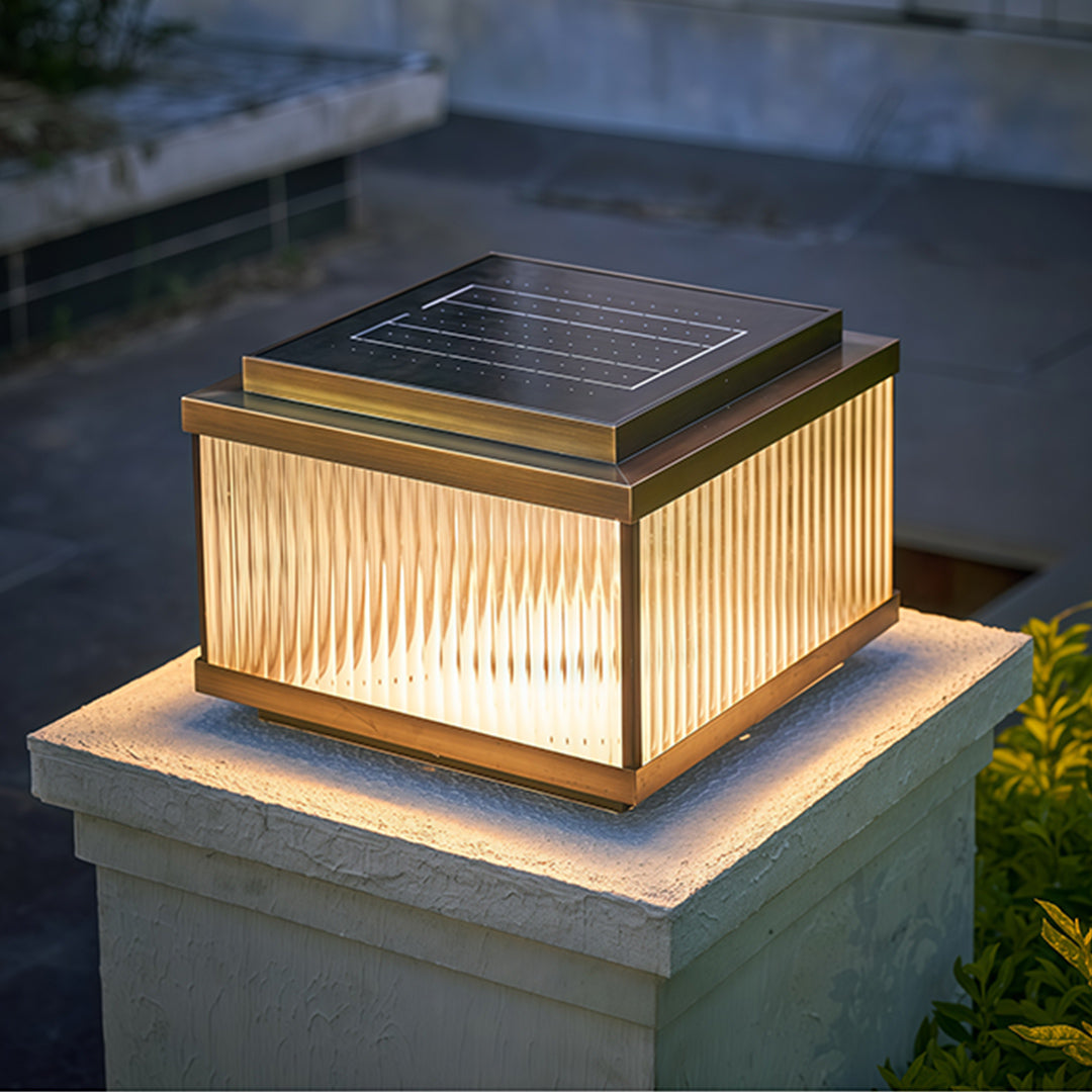 Cool white LED copper pillar light on concrete post showcasing modern minimalist outdoor lighting