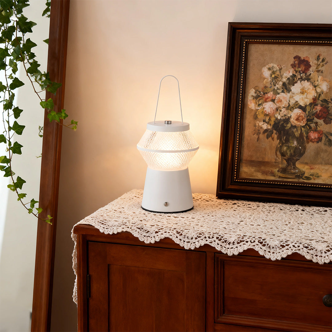 The same white led outdoor solar lantern used as a charming indoor accent on a lace-covered wooden cabinet. 