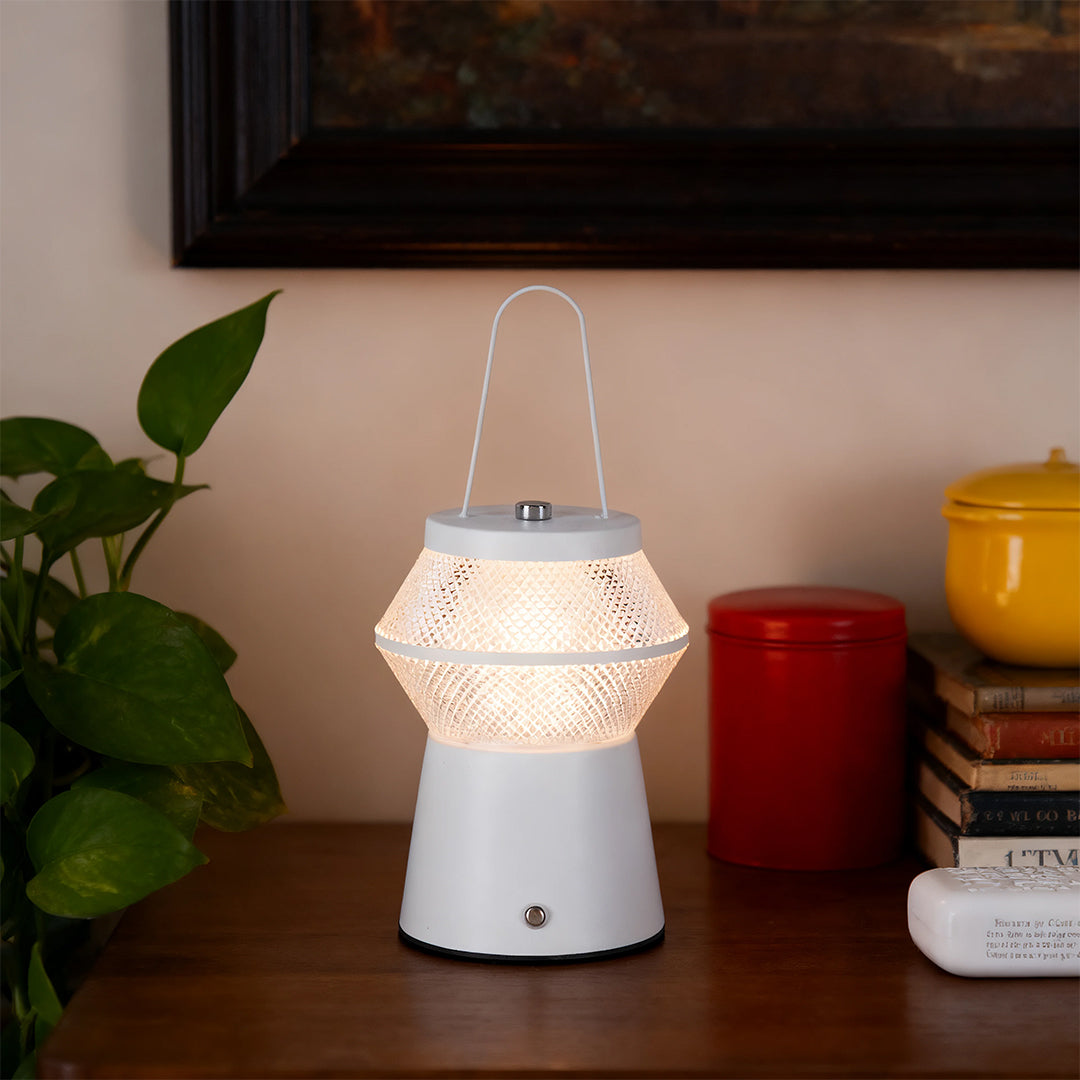 White led outdoor solar lantern with textured mesh globe providing warm light on an indoor console table. 
