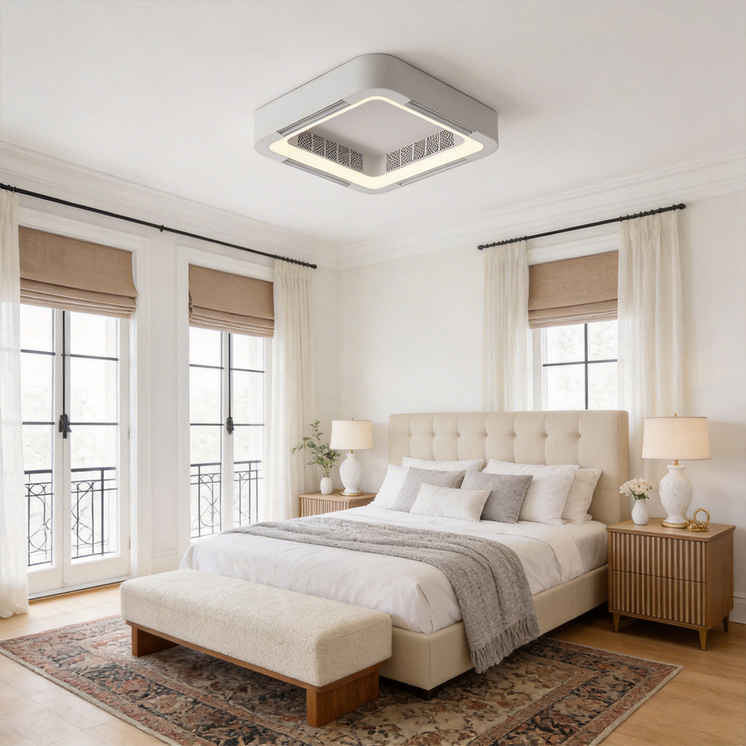 White low profile bladeless ceiling fan with light in a classic beige bedroom with big windows.