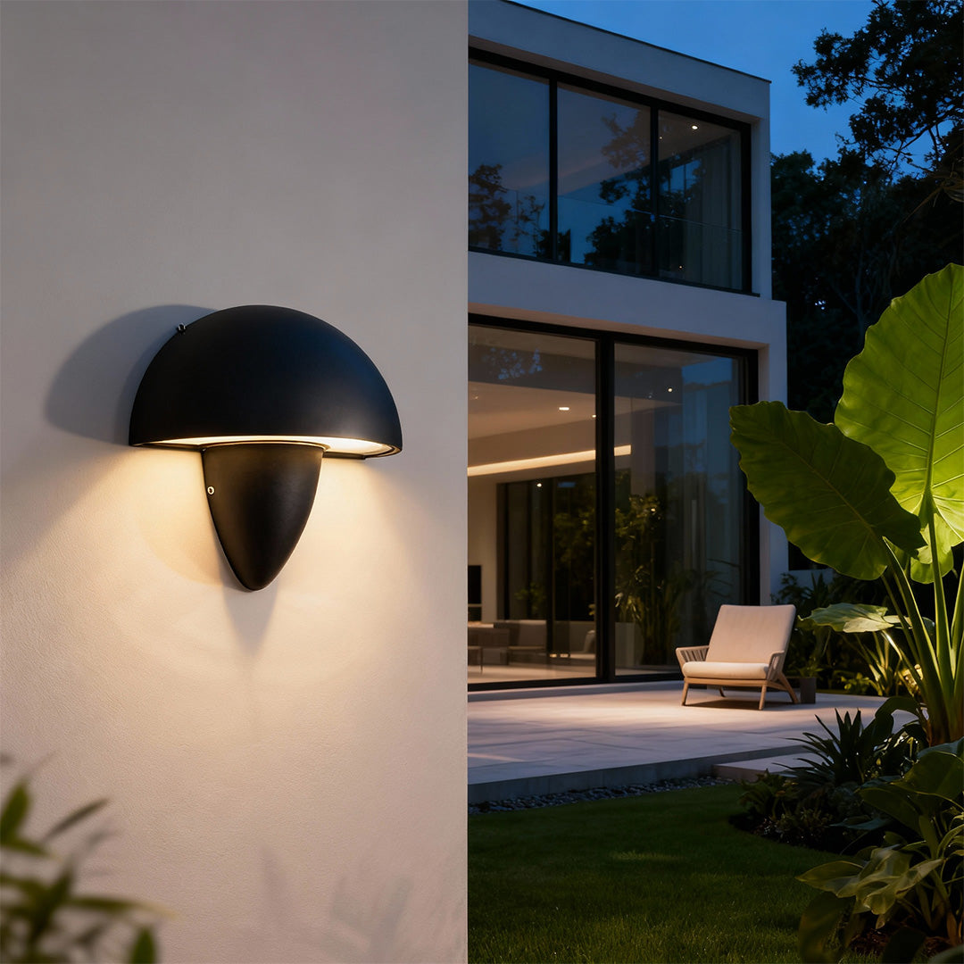 A sleek white mushroom wall light on a beige wall, offering a minimalist touch with a soft upward illumination.