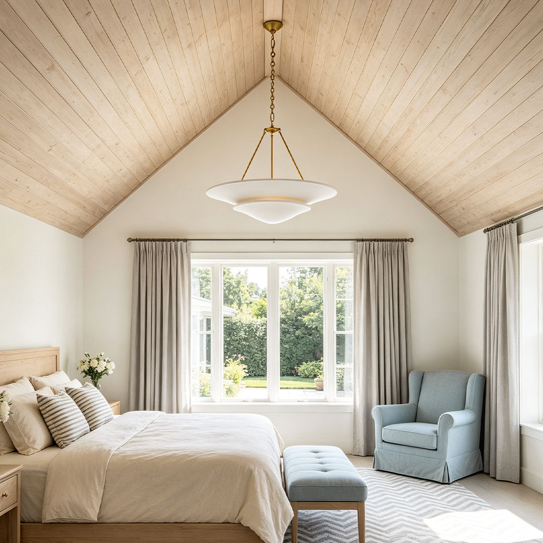 White plaster chandelier illuminating a cozy bedroom with warm minimalist interior style.
