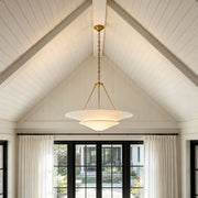 White plaster chandelier hanging in a vaulted ceiling living room with modern farmhouse design.