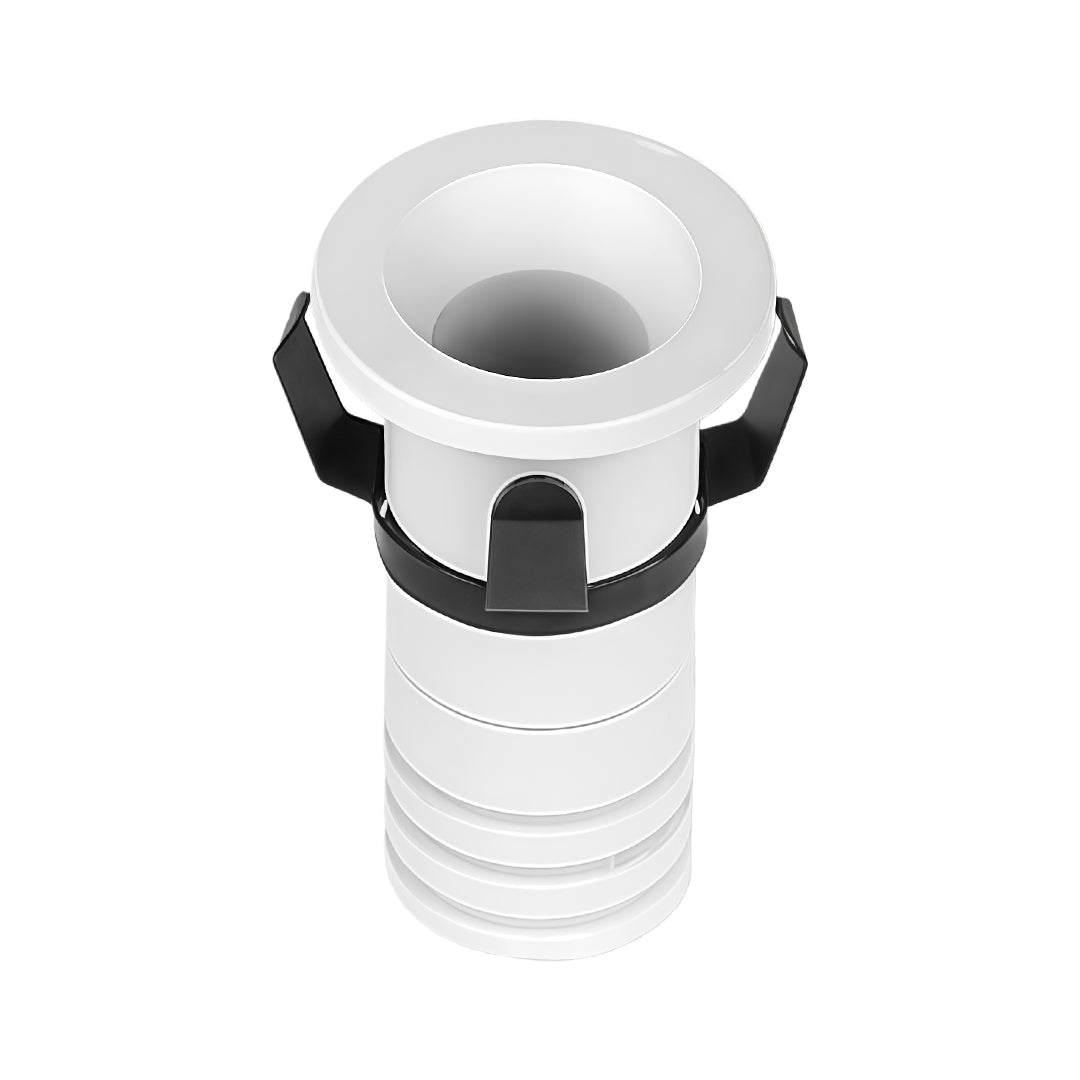 White recessed ceiling spotlight with chrome trim ring and ribbed housing for flush installation