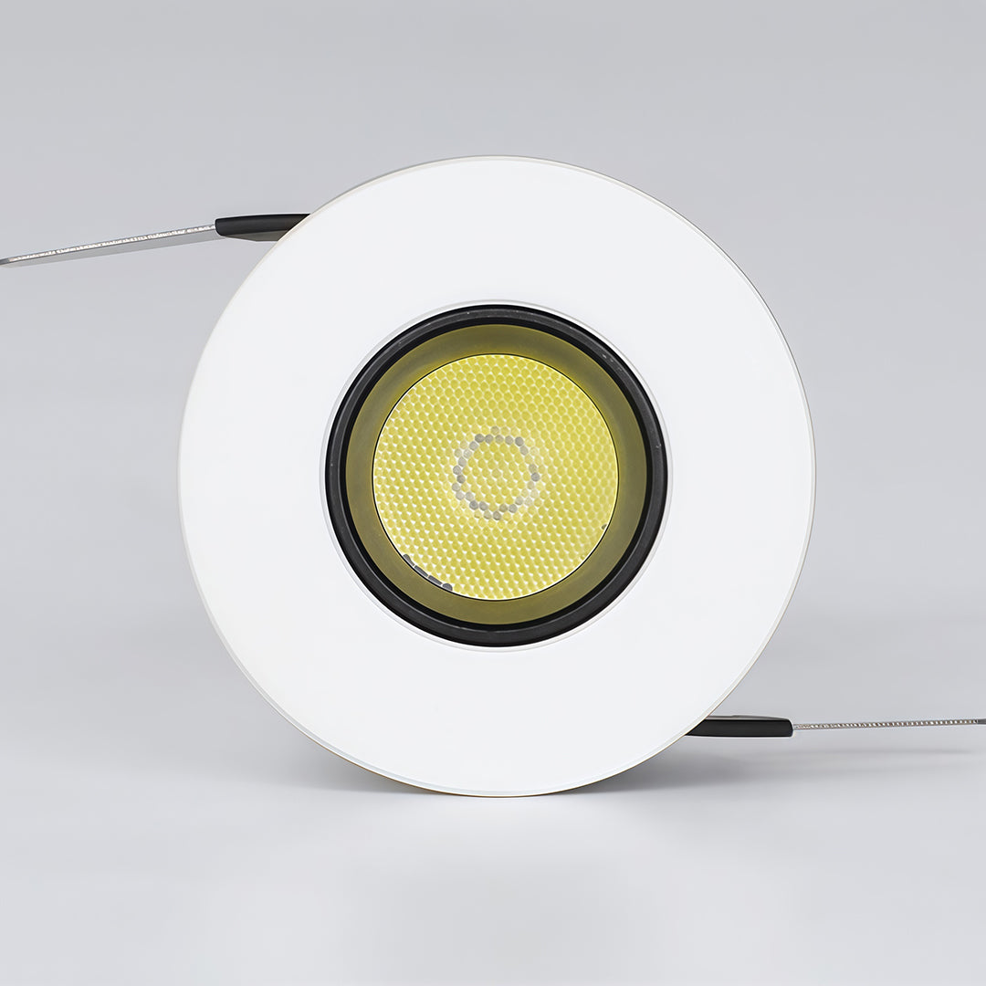 White recessed ceiling spotlight with yellow LED chip visible showing warm light output capability