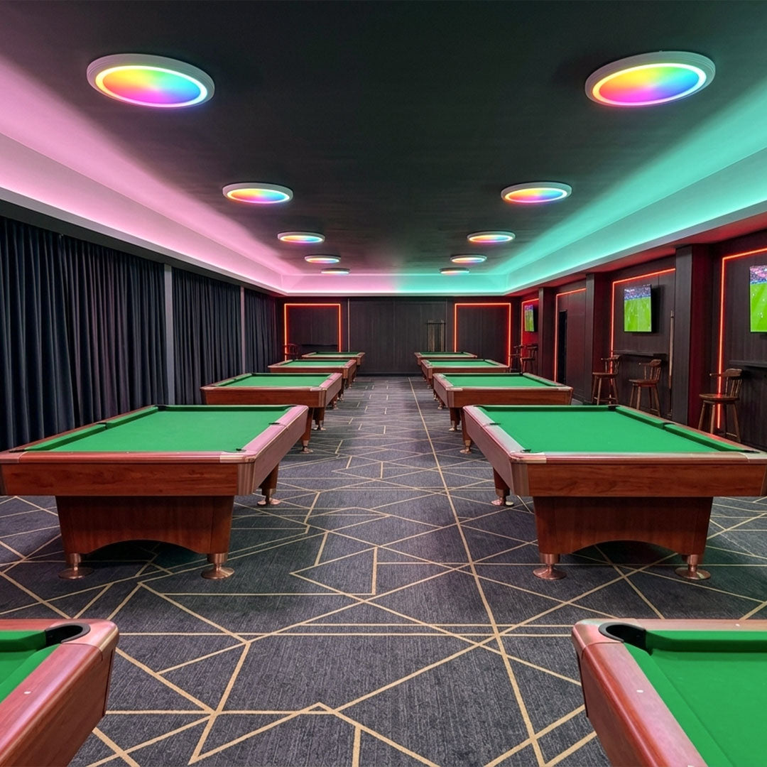 White RGB flush mount ceiling light used in a billiard game room with colorful lighting effects