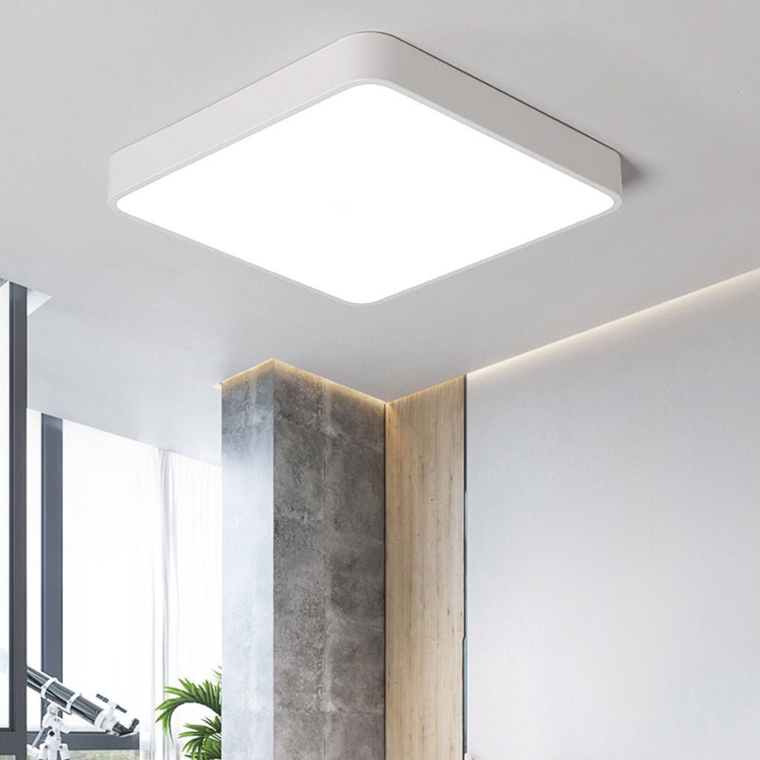 White square ceiling light mounted in a modern interior ceiling.