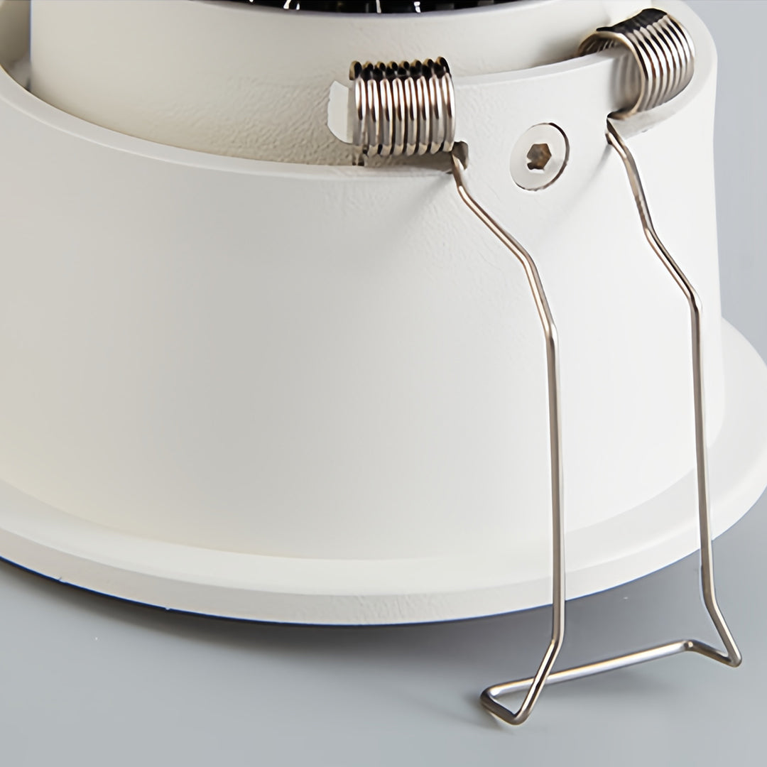 White square recessed downlight installed in a contemporary living room with ambient lighting