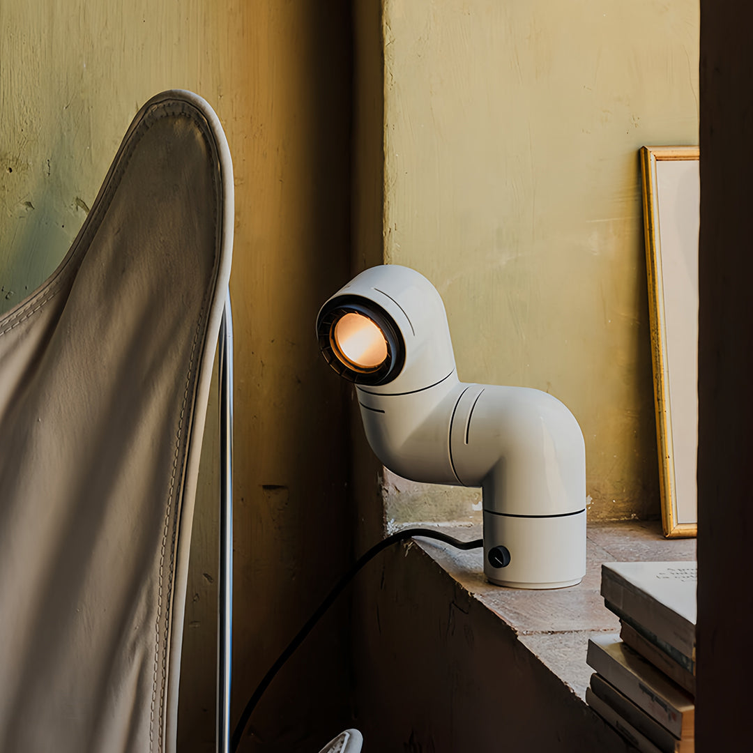 Two-tier white statement table lamp design creating artistic symmetry in a cozy room.