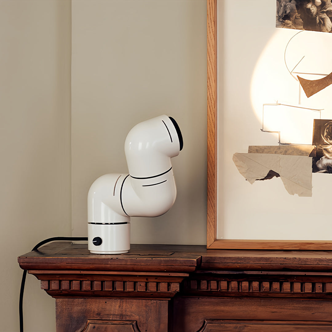 Two-tier white statement table lamp design creating artistic symmetry in a cozy room.