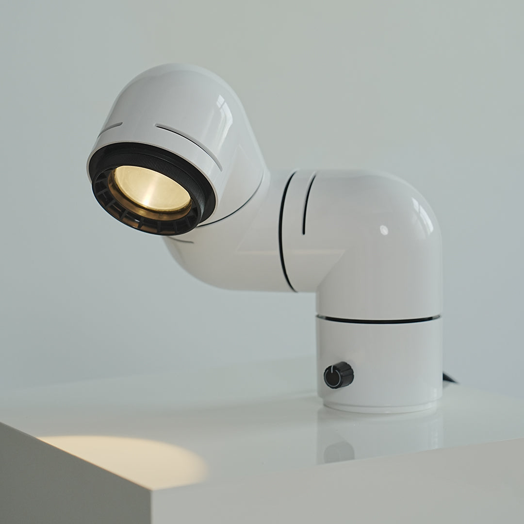 White statement table lamps with curved industrial form offering modern elegance.