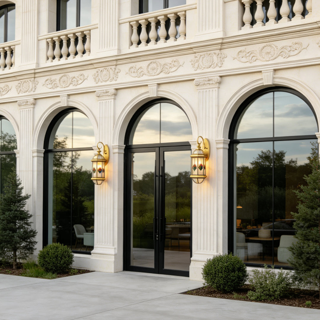 Elegant white stone mansion facade decorated with traditional Outdoor Lantern Wall Lights and large glass doors.