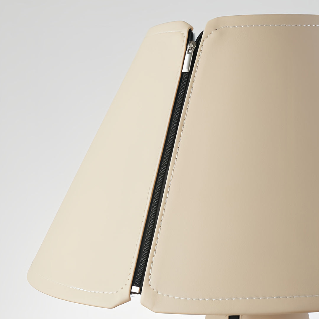 White table lamp creating cozy atmosphere on geometric patterned side table