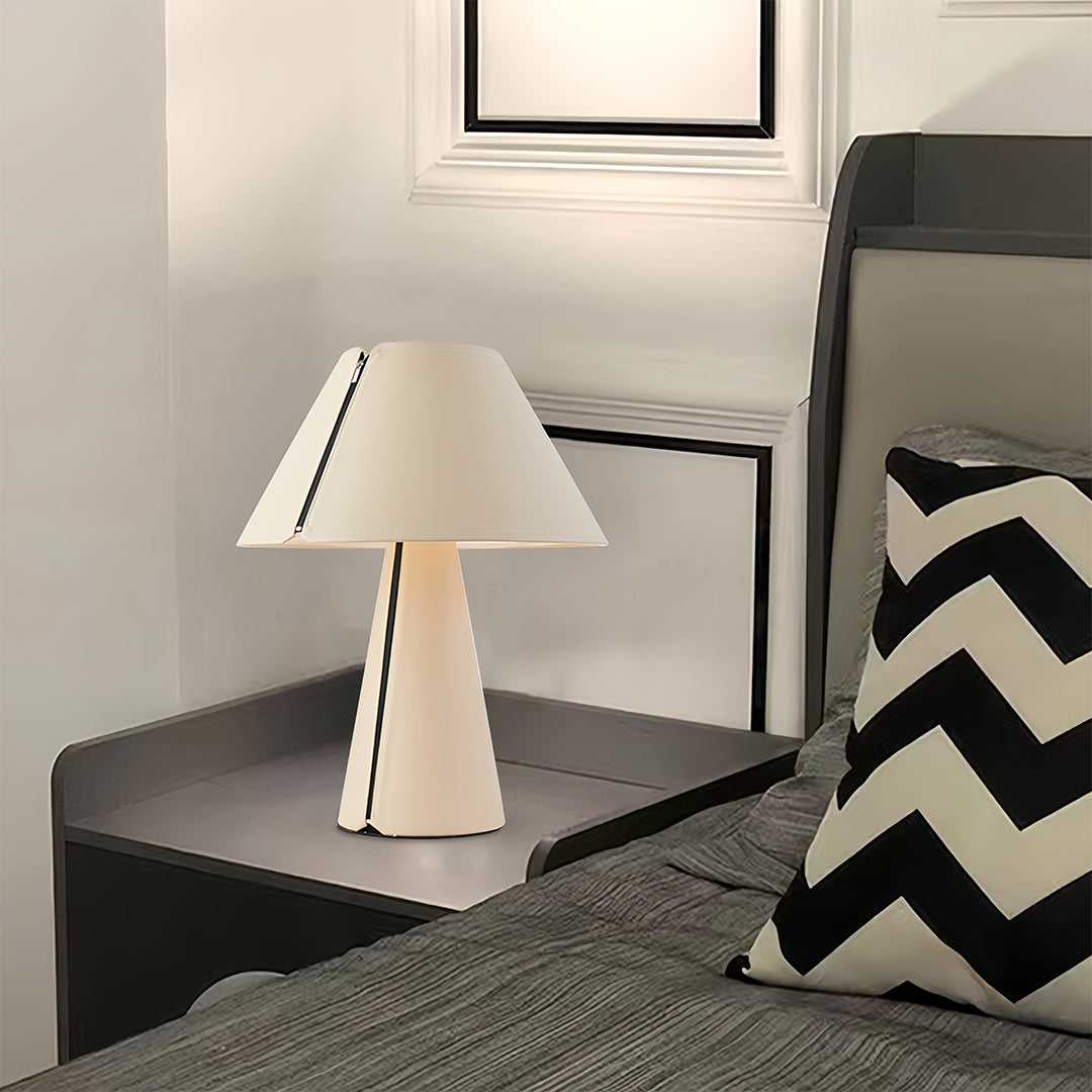 White table lamp positioned on dark surface in modern living room setting
