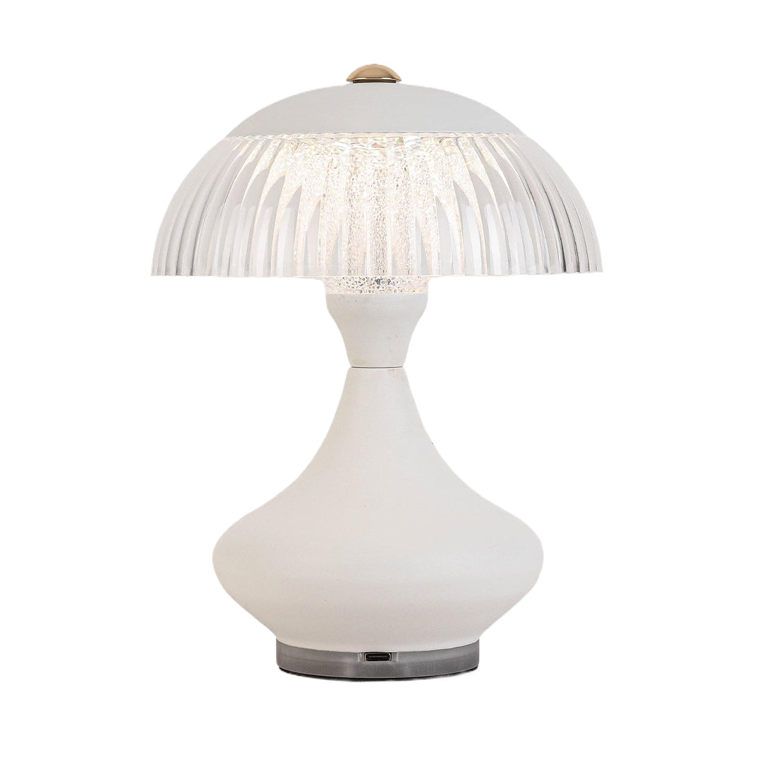 White table unique lamps with an hourglass base and clear ribbed shade, emitting a warm diffused light.