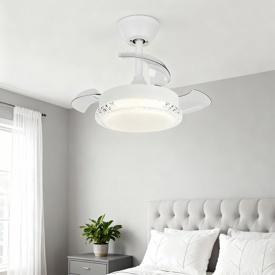 White three blade ceiling fan with light providing soft illumination in bright bedroom with white bedding.