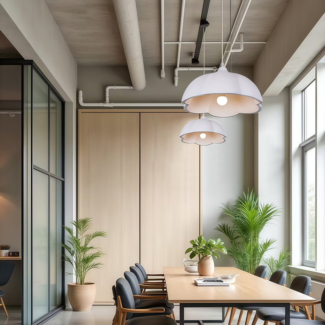 White vintage metal pendant light hanging in modern office space with natural light and wood décor.