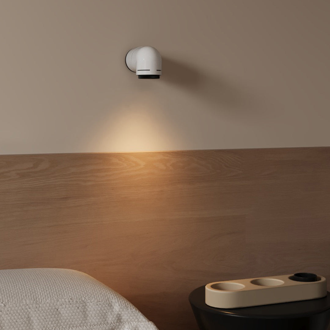 Stylish white wall modern light mounted above a mirror in a minimalist living room.