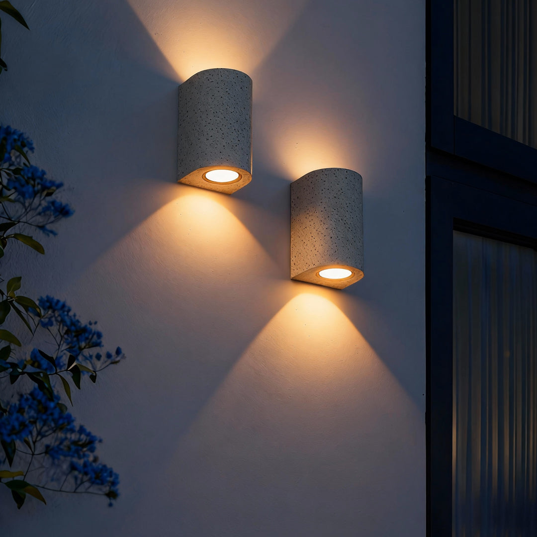 Dual-emitting up down wall lights mounted on a white exterior wall creating balanced architectural lighting.