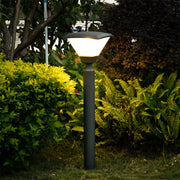 Short cylindrical bollard light with wide base and minimalist black finish