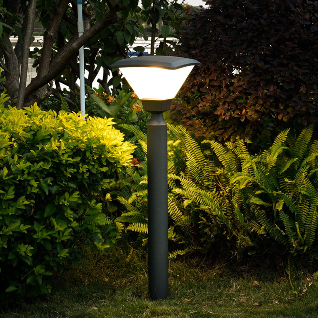 Short cylindrical bollard light with wide base and minimalist black finish