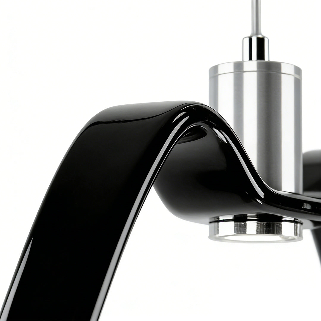 Close-up view of white wing pendant light arm and metal connector.