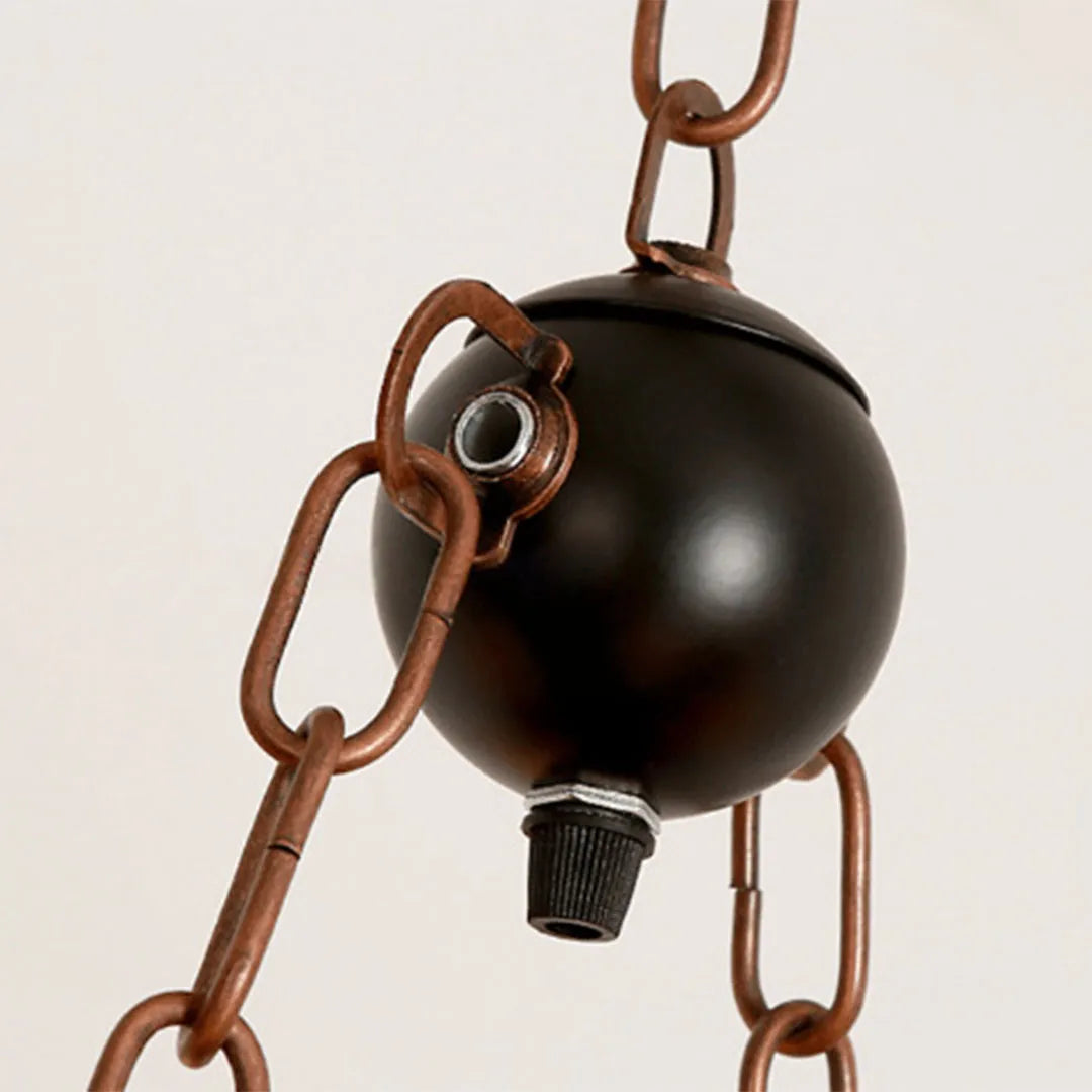 Close-up of wood and metal chandelier showing the dark metal canopy, chain, and wire connections.