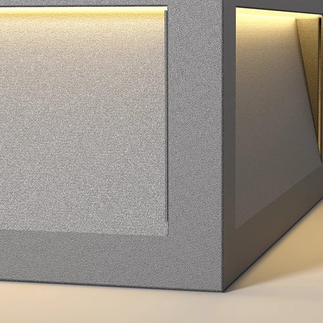 Contemporary metal pillar lights with natural wood and concrete elements creating sophisticated outdoor ambiance