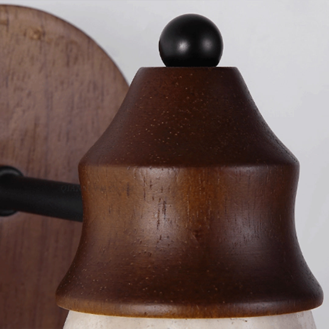 Close-up of down light wall sconce showing the dark wood housing and rounded top detail.
