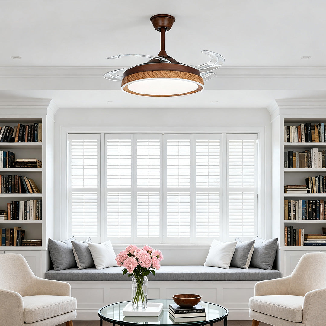 Wood grain ceiling fan with 4 lights above a cozy window seat and library shelves 