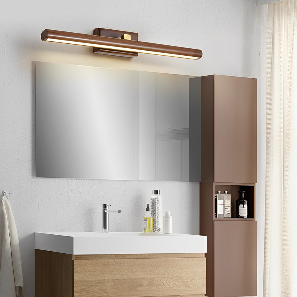 Wood and metal vanity light installed above a wall-mounted bathroom cabinet.