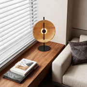 Wood modern table lamp placed on a corner table near window for cozy lighting.