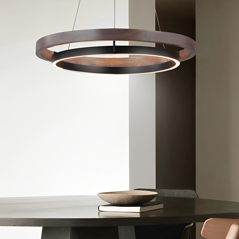 Wood ring pendant light with a sleek design, illuminating a minimalist dining area.