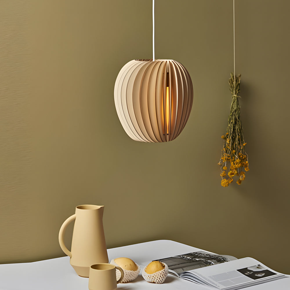 Wood slat pendant light casting a gentle glow in a minimalist dining room.