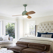 Wooden blade ceiling fan with light enhancing a cozy bedroom with warm illumination.