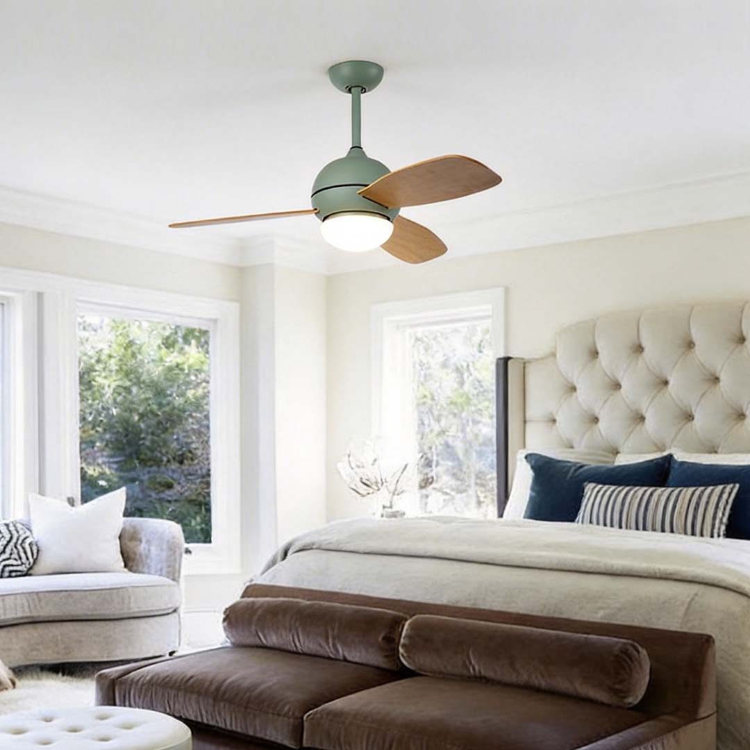 Wooden blade ceiling fan with light enhancing a cozy bedroom with warm illumination.